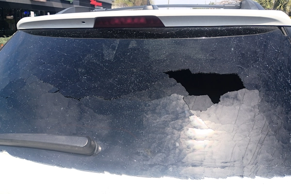 Broken fixed quarter glass behind a vehicle’s rear door